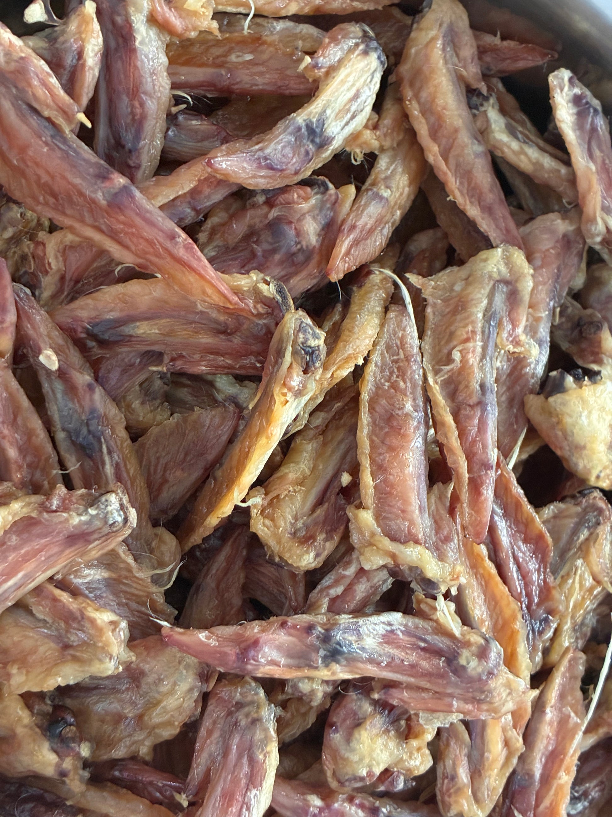 Close-up of dried fish pieces in a metal container